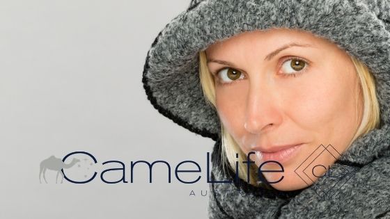 Mature woman in winter clothes protected by came milk skincare